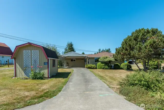 Paved driveway to carport and front door