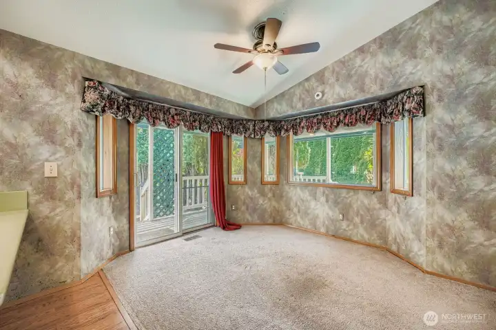 Dining room open to the kitchen and the living room. Enjoy vaulted ceilings for an even more spacious feeling. Wood wrapped windows throughout.