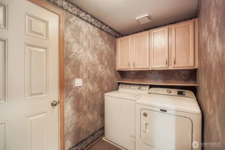 Utility room with cabinets. Leads to the 2 car garage.