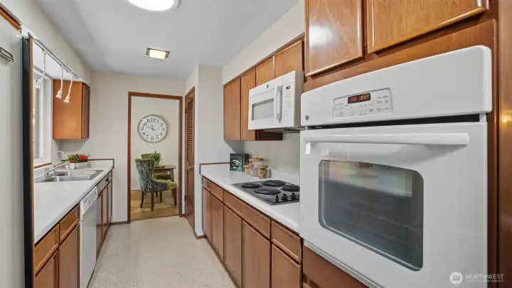 Efficient cooking space with ample cabinetry and direct dining access.