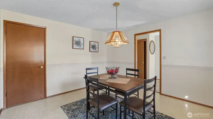 Enjoy meals in this classic dining room with charming light fixture and a cozy atmosphere.