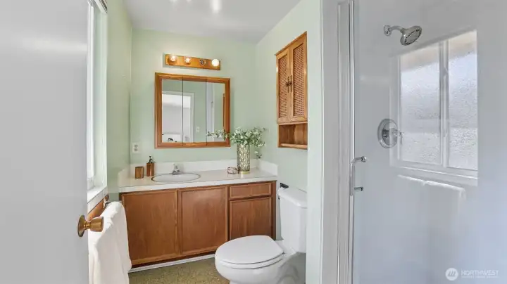 Enjoy the convenience of a private bath with vanity storage and walk-in shower.