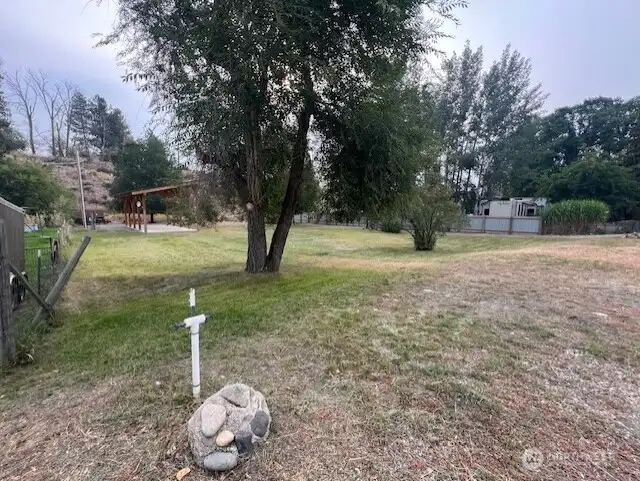 Level, irrigated lot with lush green lawn and natural privacy. Irrigation from MVID.