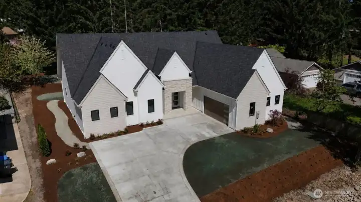 Driveway & landscaping just went in. Don't miss the HUGE storage area above the garage!