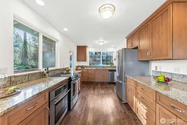 Kitchen-Looking towards the side door out to the wrap around deck- Walk-in pantry is just to the right past the fridge