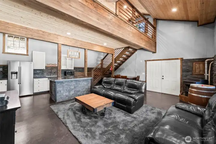 Open concept living room with vaulted ceilings and natural light.