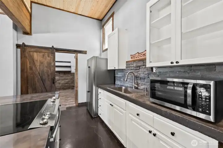 Updated kitchen with white cabinetry, modern appliances, and clean finishes.