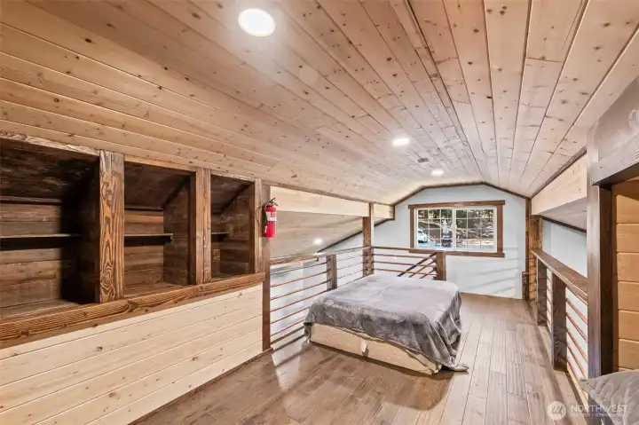 Loft bedroom with rustic wood interior and flexible sleeping space.