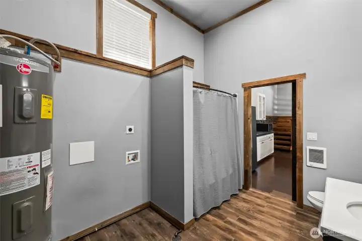 Utility and full bathroom. Shower / tub, and additional storage space.