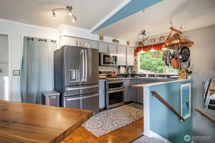 This open kitchen features a double oven that allows for multiple cooking options.