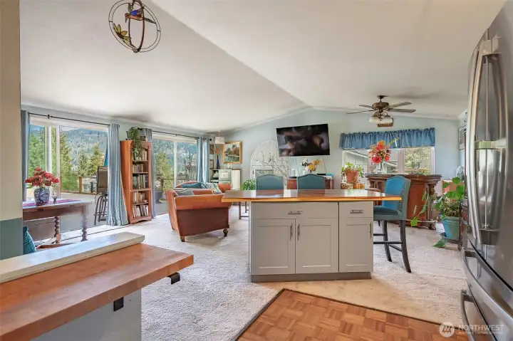This view from the kitchen highlights the seamless openness of the living room, with two expansive sliding doors that lead to a spacious outdoor patio—perfect for indoor-outdoor living.