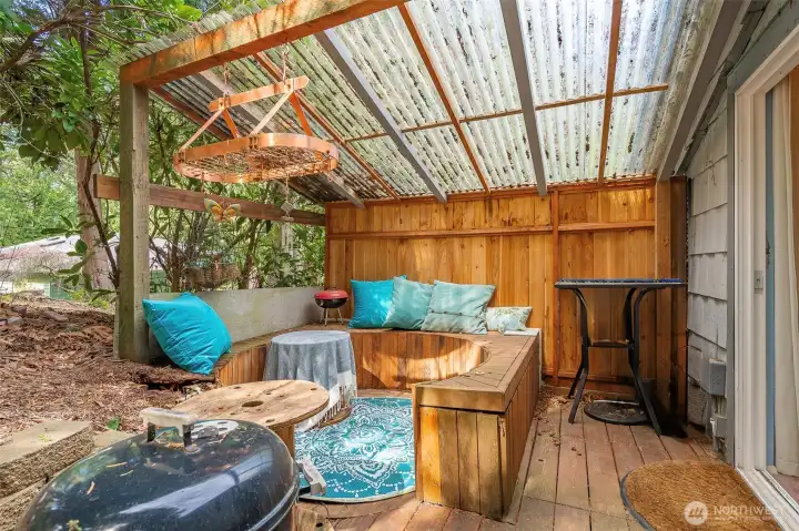 Quaint covered patio area off bedroom #2 that's currently used as an art studio.