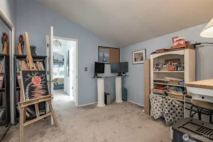 Another view of bedroom #2 with a view of bedroom #1 in the distance.  An updated bathroom is located between both bedrooms to the right.