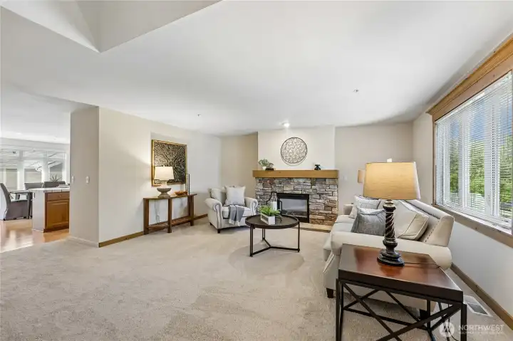 Spacious family room with a gas fireplace and windows bringing the sunshine in!