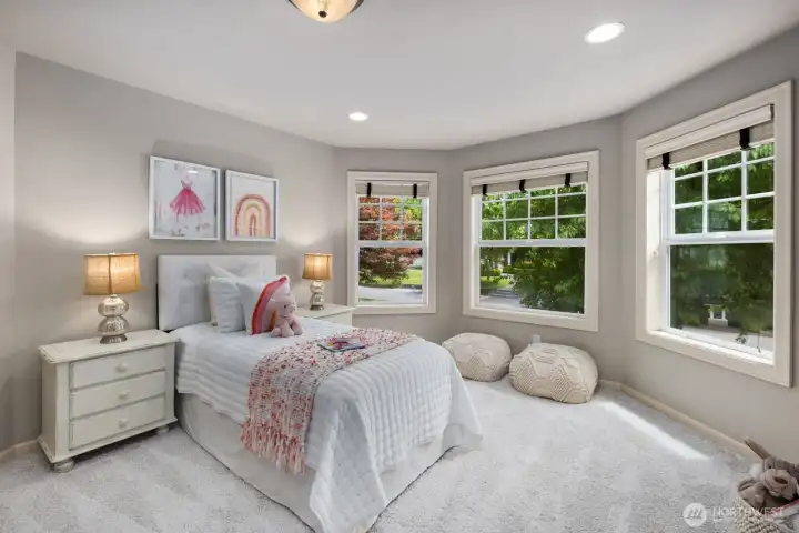Picture windows and plush carpeting anchor secondary bedrooms overlooking the front exterior. Picture windows and plush carpeting anchor secondary bedrooms overlooking the front exterior.