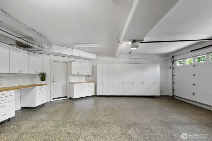 Well-appointed three-car garage with epoxy flooring, integrated workbench and full-height storage. Well-appointed three-car garage with epoxy flooring, integrated workbench and full-height storage.