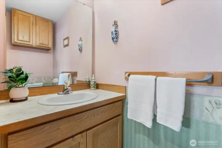 Charming main-floor powder room located off the living area, offering convenient guest access and a seamless flow.