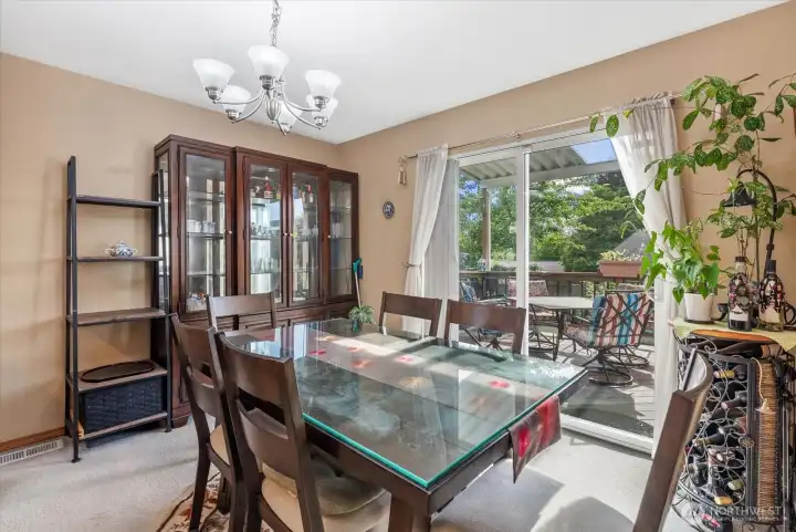 This spacious dining area features direct access to the outdoor entertainment deck and backyard, perfect for hosting and indoor-outdoor living.