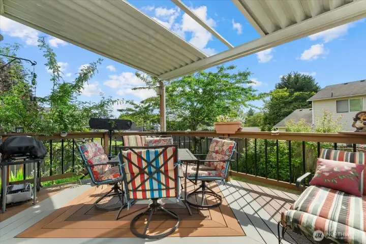 Spacious entertainment deck equipped with an integrated heater, perfect for enjoying the outdoors even on cooler evenings.