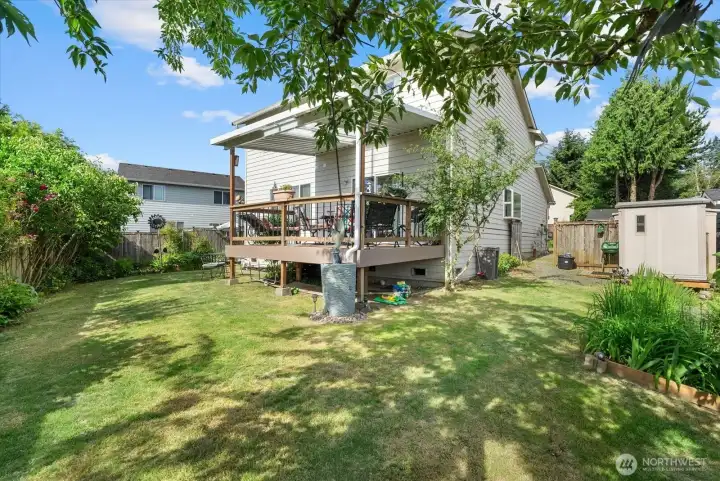 This property features a beautifully landscaped yard equipped with a sustainable rainwater harvesting system.