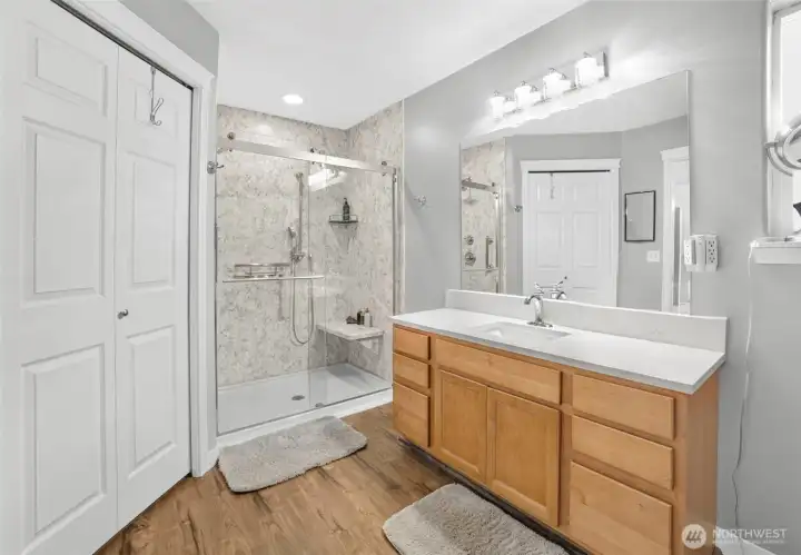 Updated primary bathroom with quartz countertop, tiled stand in shower, closet. Updated primary bathroom with quartz countertop, tiled stand in shower, closet.