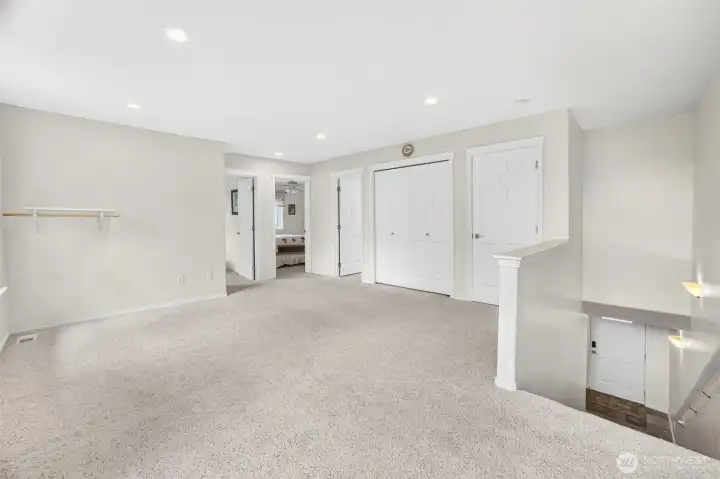 Upstairs landing showing secondary living/family room, open layout two storage closets. Upstairs landing showing secondary living/family room, open layout two storage closets.