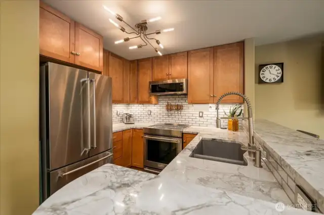 Marble countertops, solid wood cabinetry, under counter lighting.