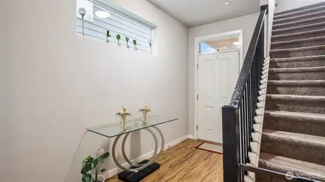 Laminate flooring at the entry extends throughout the main living areas.