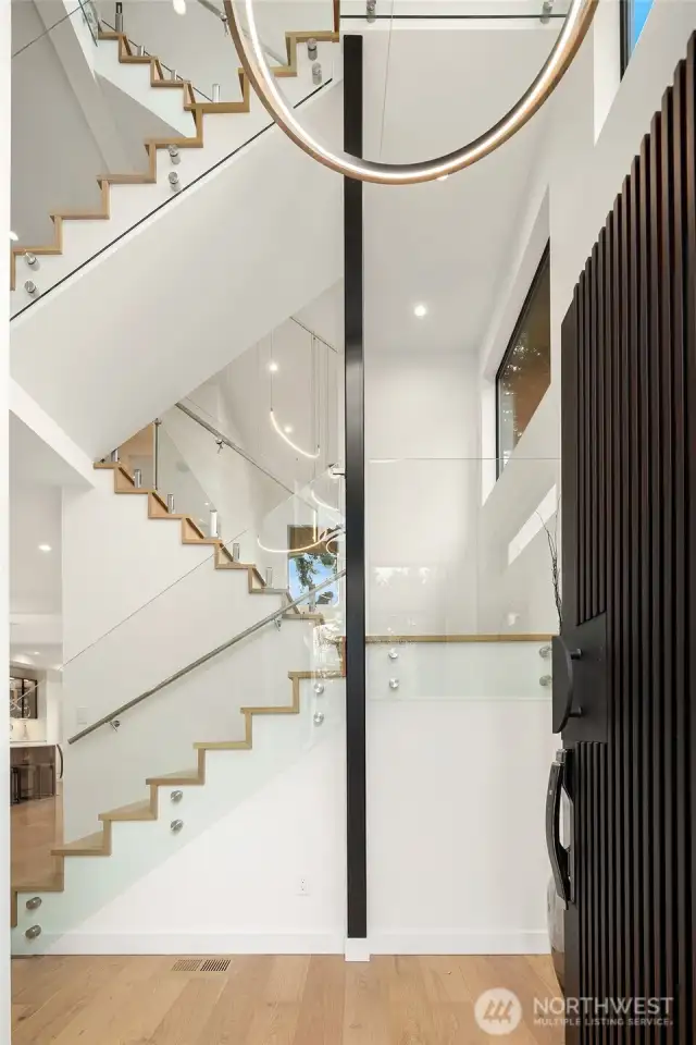 Luxurious staircase with glass railings.