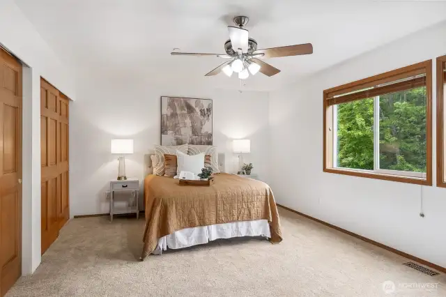 Primary bedroom with greenspace views.