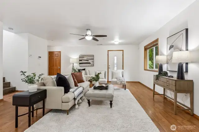 Open living space with ceiling fan.