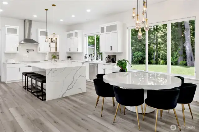 Open concept kitchen/dining areas are anchored by a massive granite island, ideal for entertaining.
