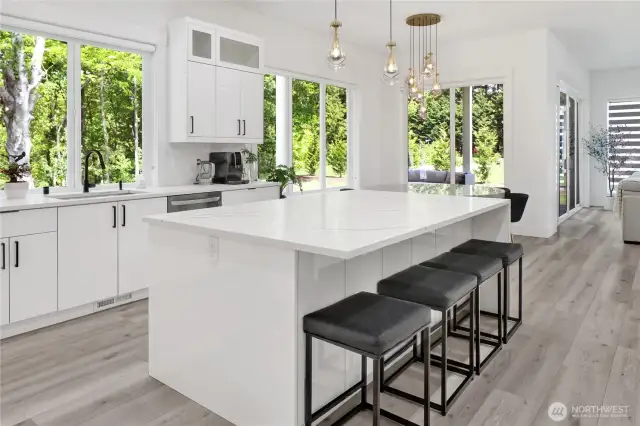Imagine working in the kitchen with these gorgeous nature views! Island with eating bar,