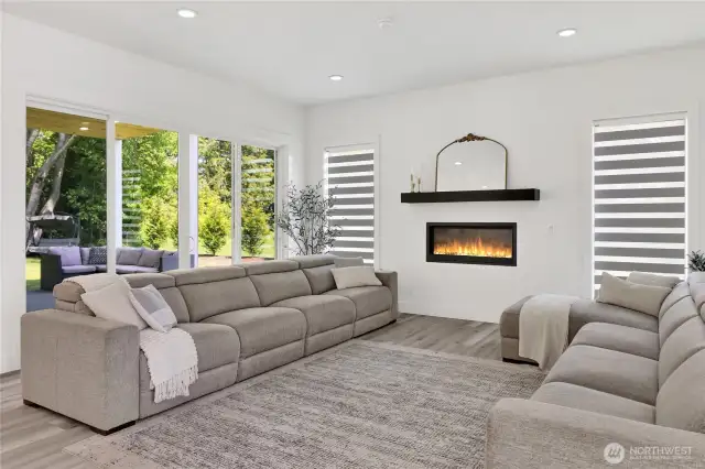 Family room with cozy fireplace and large sliding glass door to covered deck