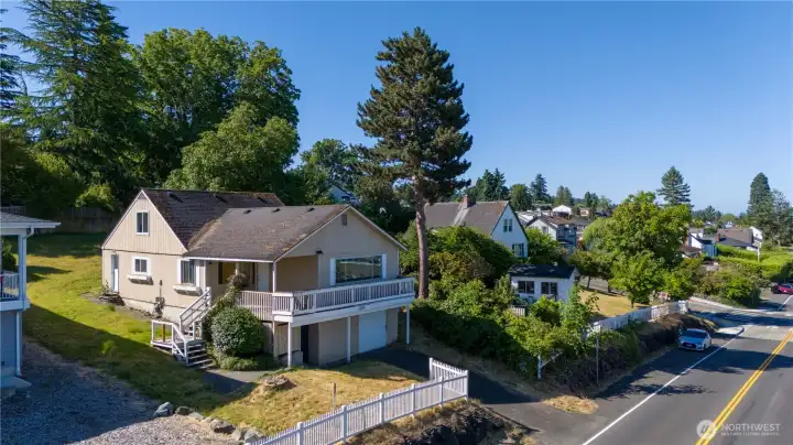 Alley (unused) in back is potential for adding a detached garage.  Then create additional living space in the basement/garage on the view side. A possible roof change could add more living space above to absorb the views. Buyer to verify.