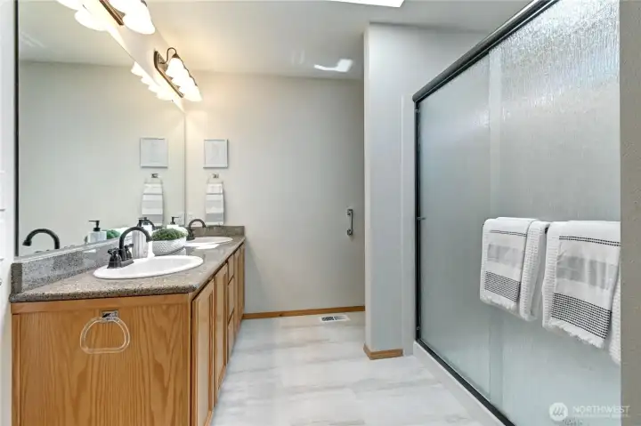 Spacious primary with dual sinks, large walk-in shower