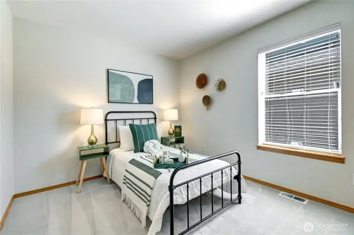 2nd of 3 bedrooms at the end of the hallway.
