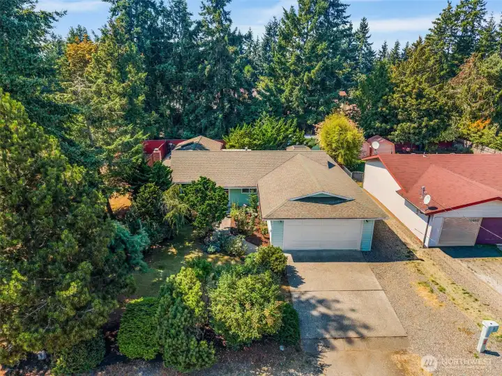 Charming 3-bedroom, 2-bath home set back from the street with mature landscaping for added privacy. Inviting curb appeal with established trees and greenery surrounding the property.