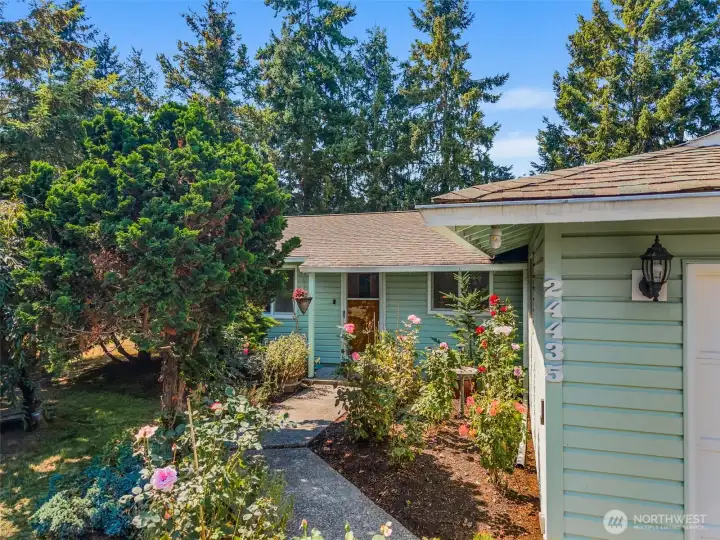 Welcoming entry with an established rose garden, adding color and character to the home’s exterior.