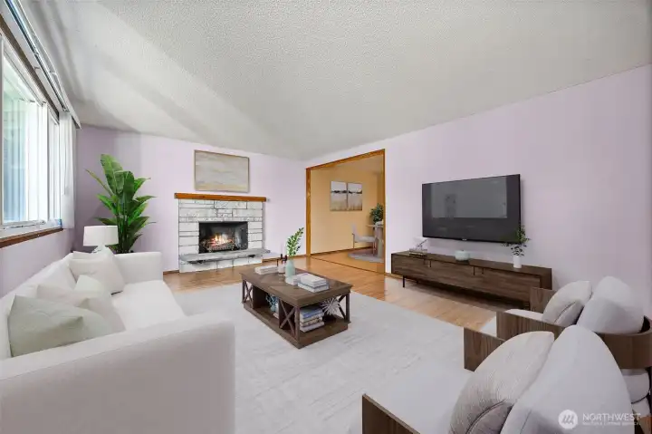 Virtually Staged. Bright and spacious living room with large windows, natural light, and a cozy wood-burning fireplace — perfect for entertaining or relaxing on cool Pacific Northwest evenings.