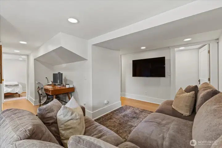 Finished basement with separate entry, featuring bedroom, living area, and flex space. Ideal for guests!