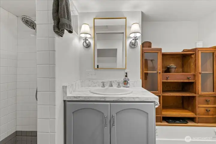 Lower level bathroom featuring tile walk in shower and ample storage!