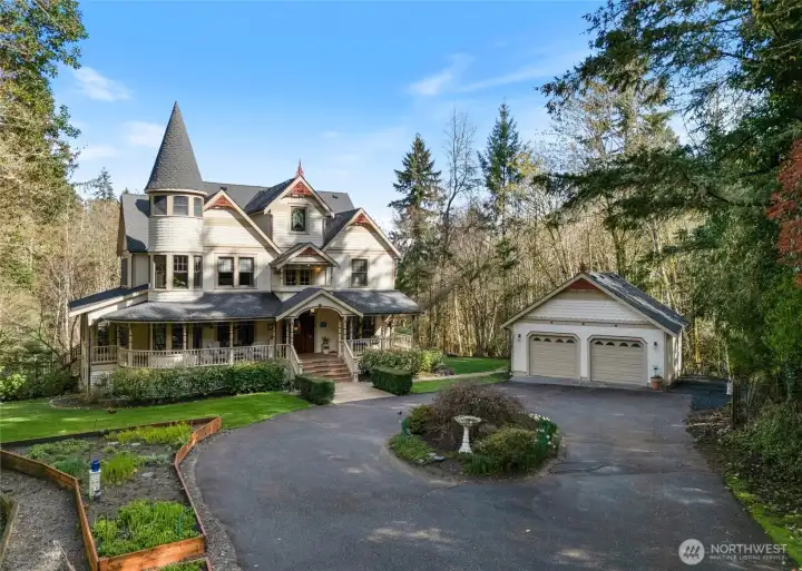 A detached 2-car garage also includes a potting shed/yard tool space behind.