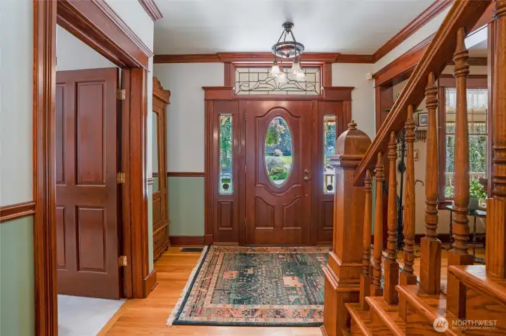 Rich solid-wood millwork enhances the beaty of this home. The foyer is stunning with its grand staircase, crown molding, hardwood flooring, and attention to detail.