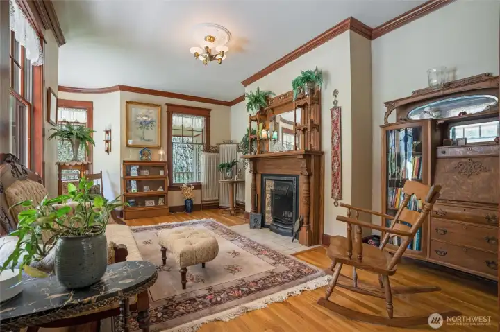 Crown molding, solid wood fireplace mantle, and vintage light fixture decorates this room beautifully.