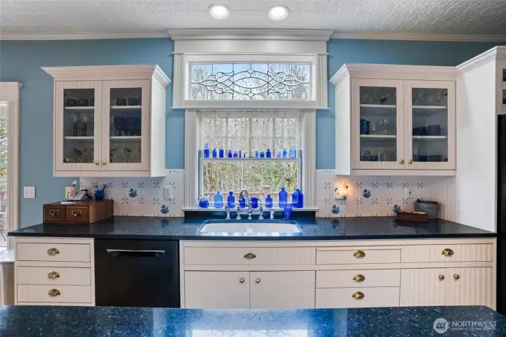 Lovely territorial views can be enjoyed while washing dishes or preparing a meal.  An expansive island enjoys a ton of storage underneath. This kitchen is light and bright and a chef's delight.