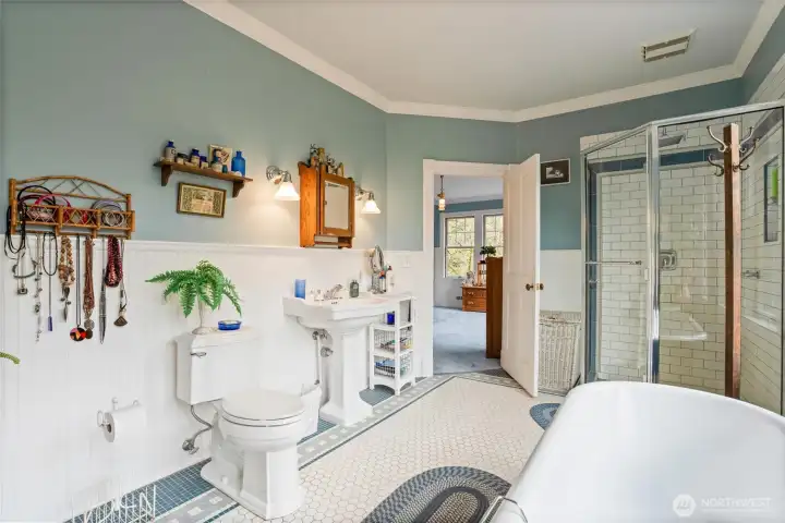 Another view of the primary bath with pedestal sink and large walk-in shower.