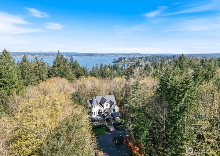 Aerial view of this Victorian home nestled in the woods near Kopachuck State Park in Gig Harbor, WA.