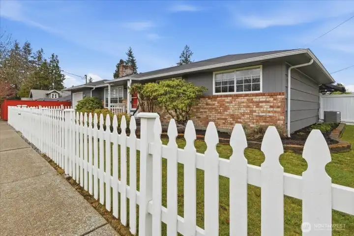 Charming white picket fence adds so much curb appeal to the home.