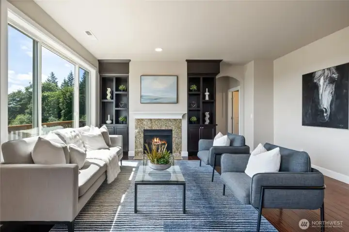 Living room with built-in shelving and large picture windows